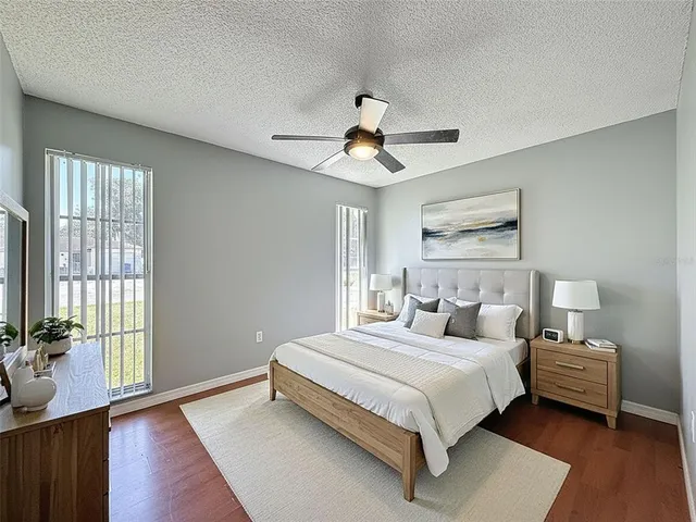 a bedroom with a large bed and a chandelier