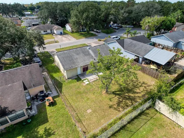 an aerial view of multiple houses with yard