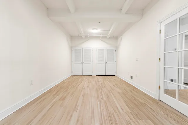 an empty room with wooden floor