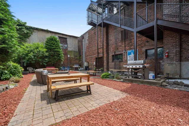 a view of a patio with a table and chairs