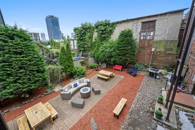 a view of a chairs and table in backyard