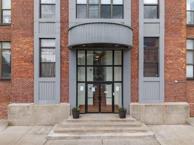 a view of a brick house with large windows