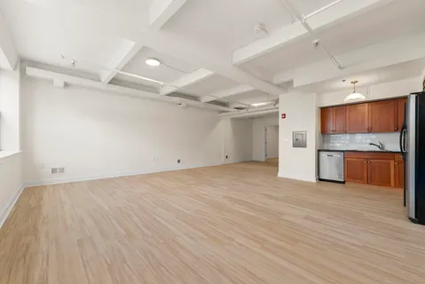 a view of a kitchen with a sink and a refrigerator