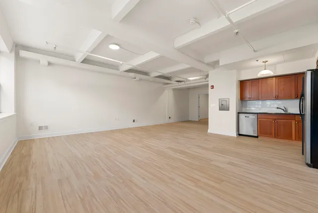 a view of a kitchen with a sink and a refrigerator