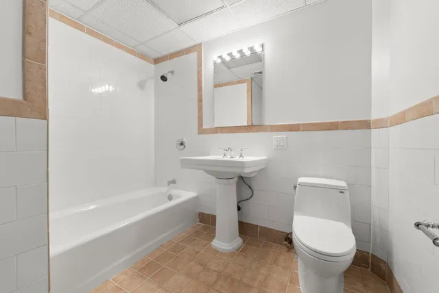 a bathroom with a sink toilet and a bathtub
