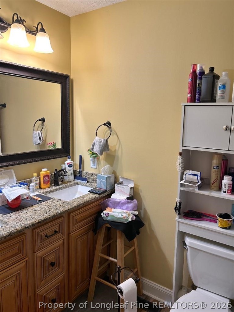 3085 Westminster Road Lumberton, NC 28360 - Photo 12 of 19 a bathroom with a granite countertop sink vanity mirror and toilet