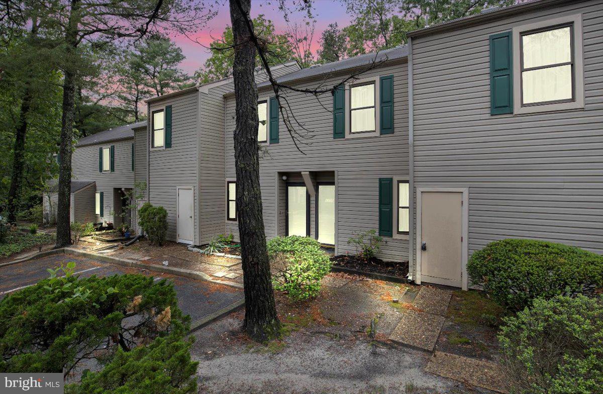 1105 Bromley Estate Pine Hill, NJ 08021 - Photo 1 of 27 a view of a house with brick walls plants and large tree