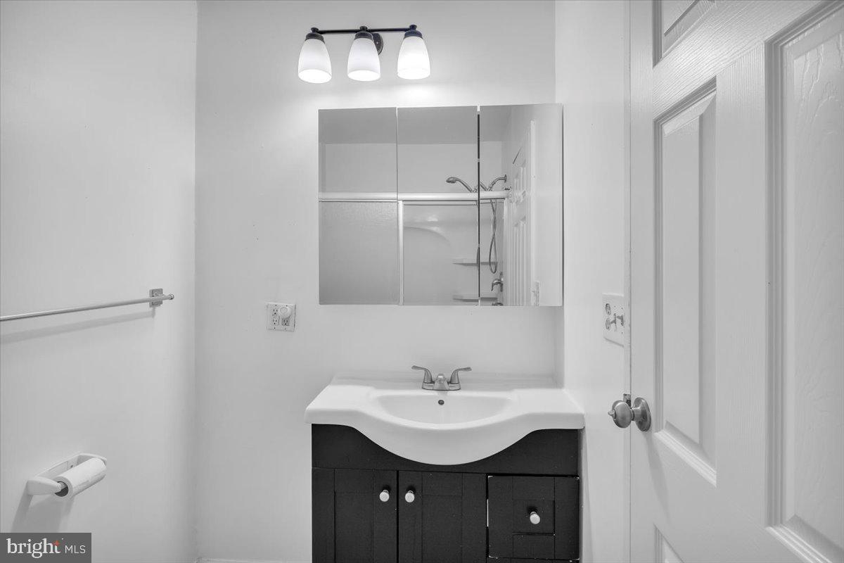 1105 Bromley Estate Pine Hill, NJ 08021 - Photo 13 of 27 a bathroom with a sink a light fixture and a mirror