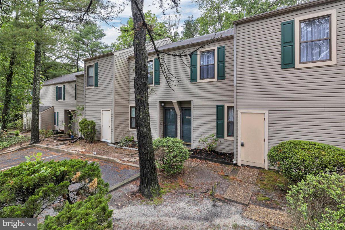 1105 Bromley Estate Pine Hill, NJ 08021 - Photo 21 of 27 a view of a house with a yard and plants