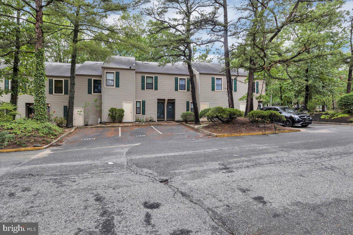 1105 Bromley Estate Pine Hill, NJ 08021 - Photo 27 of 27 a front view of a house with a yard and large trees