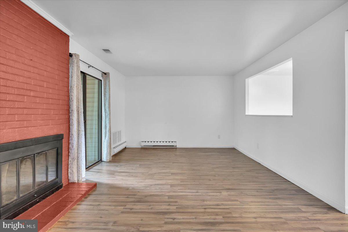 1105 Bromley Estate Pine Hill, NJ 08021 - Photo 6 of 27 an empty room with wooden floor and windows