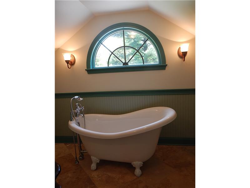 105 Eckstein Road Renfrew, PA 16053 - Photo 12 of 25 Master Bath/Spa. Charming en suite bath features a claw foot soaking tub and travertine flooring.