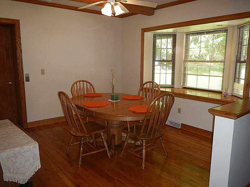 105 Eckstein Road Renfrew, PA 16053 - Photo 6 of 25 Dining Room. Dining room with hardwood flooring , a bay window, and a ceiling fan
