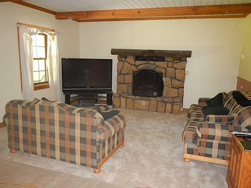 105 Eckstein Road Renfrew, PA 16053 - Photo 7 of 25 Living Room. The living room features a log burning stone fireplace
