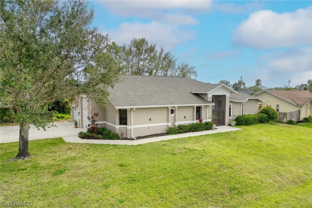 17501 Homewood Road Fort Myers, FL 33967 - Photo 1 of 50 a front view of house with yard and trees