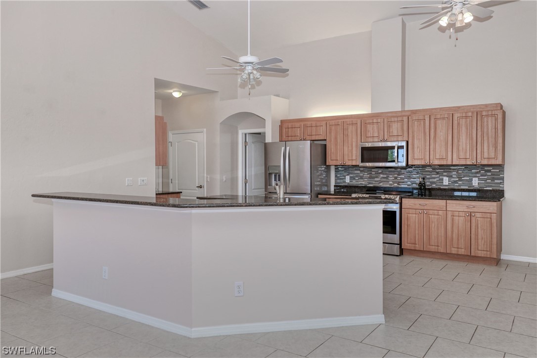 17501 Homewood Road Fort Myers, FL 33967 - Photo 14 of 50 a kitchen with stainless steel appliances a sink stove and cabinets