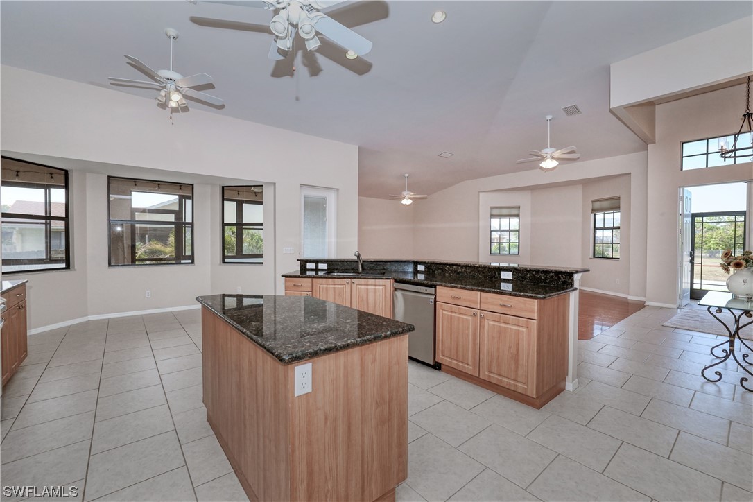 17501 Homewood Road Fort Myers, FL 33967 - Photo 17 of 50 a kitchen with granite countertop a sink counter top space appliances and a window