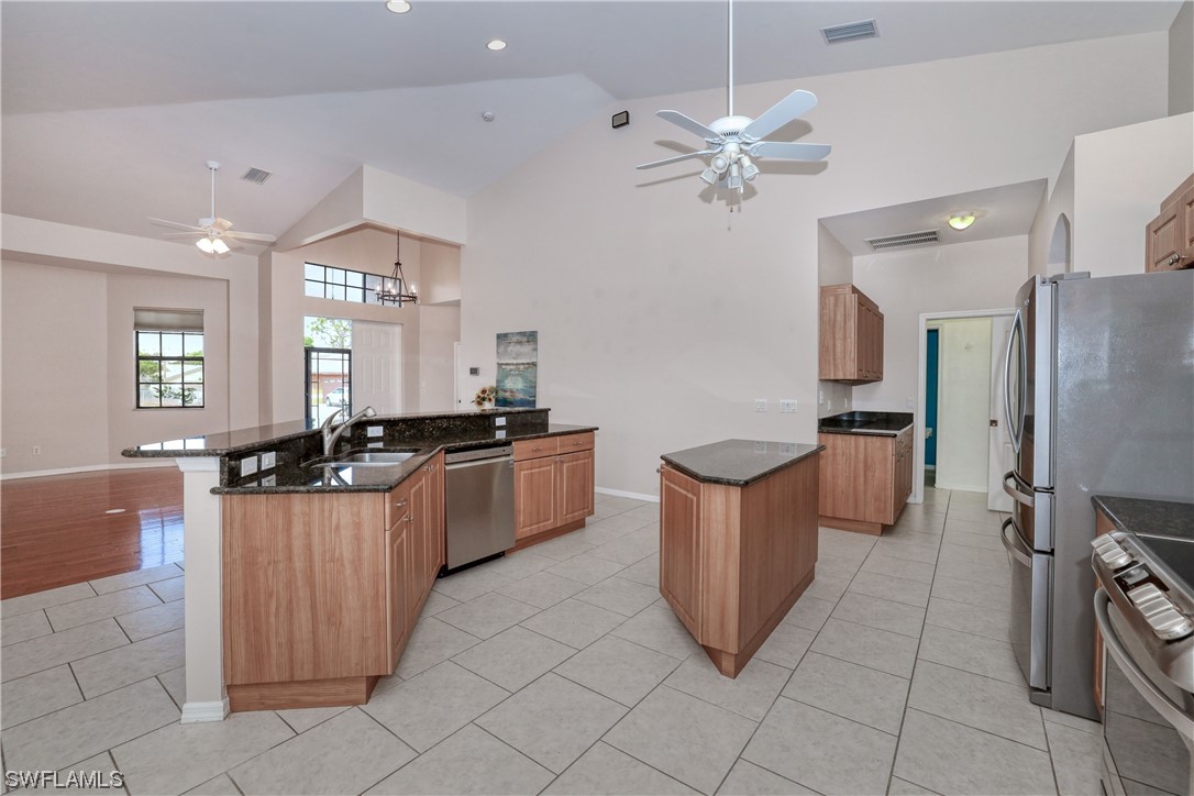 17501 Homewood Road Fort Myers, FL 33967 - Photo 18 of 50 a kitchen with stainless steel appliances a sink a counter top space cabinets and wooden floor