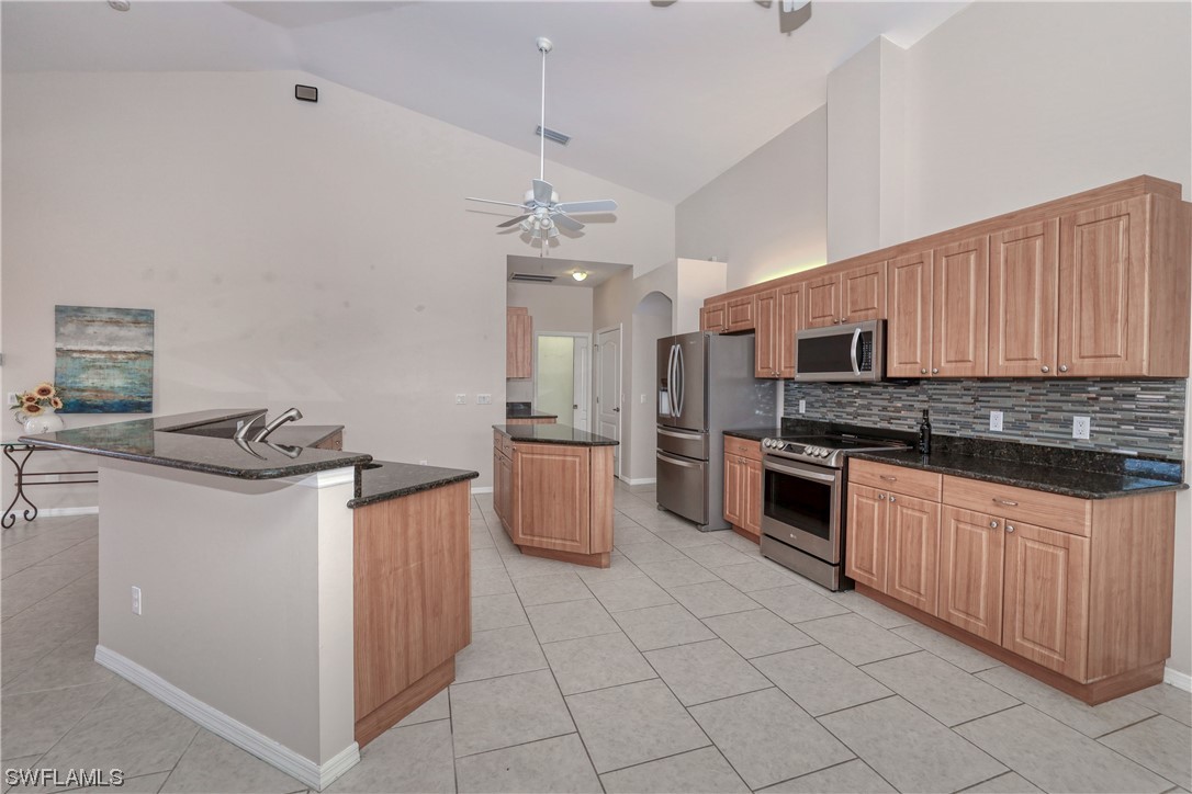 17501 Homewood Road Fort Myers, FL 33967 - Photo 20 of 50 a kitchen with stainless steel appliances a stove sink and microwave