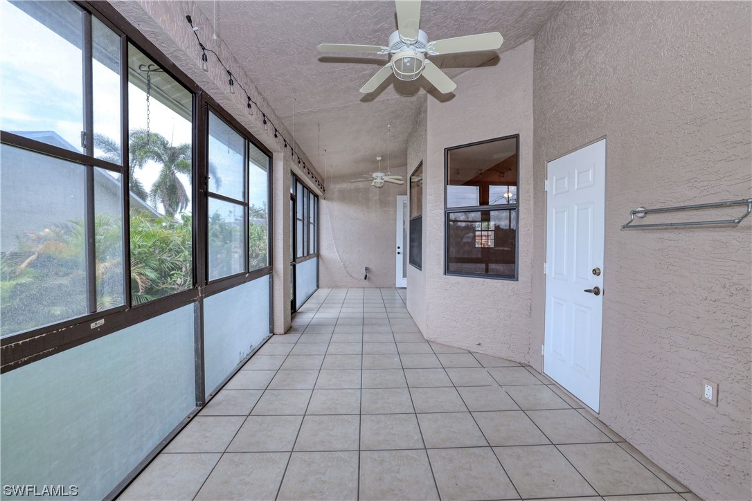 17501 Homewood Road Fort Myers, FL 33967 - Photo 26 of 50 a view of a hallway with a chandelier fan and windows