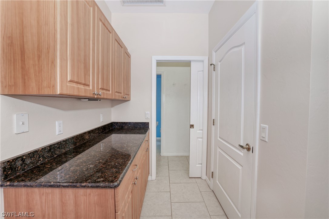 17501 Homewood Road Fort Myers, FL 33967 - Photo 28 of 50 a kitchen with granite countertop a sink and cabinets