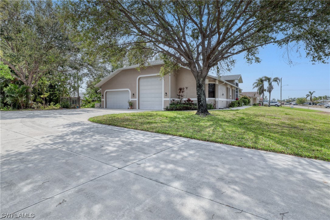 17501 Homewood Road Fort Myers, FL 33967 - Photo 3 of 50 a view of a house with a yard and large trees