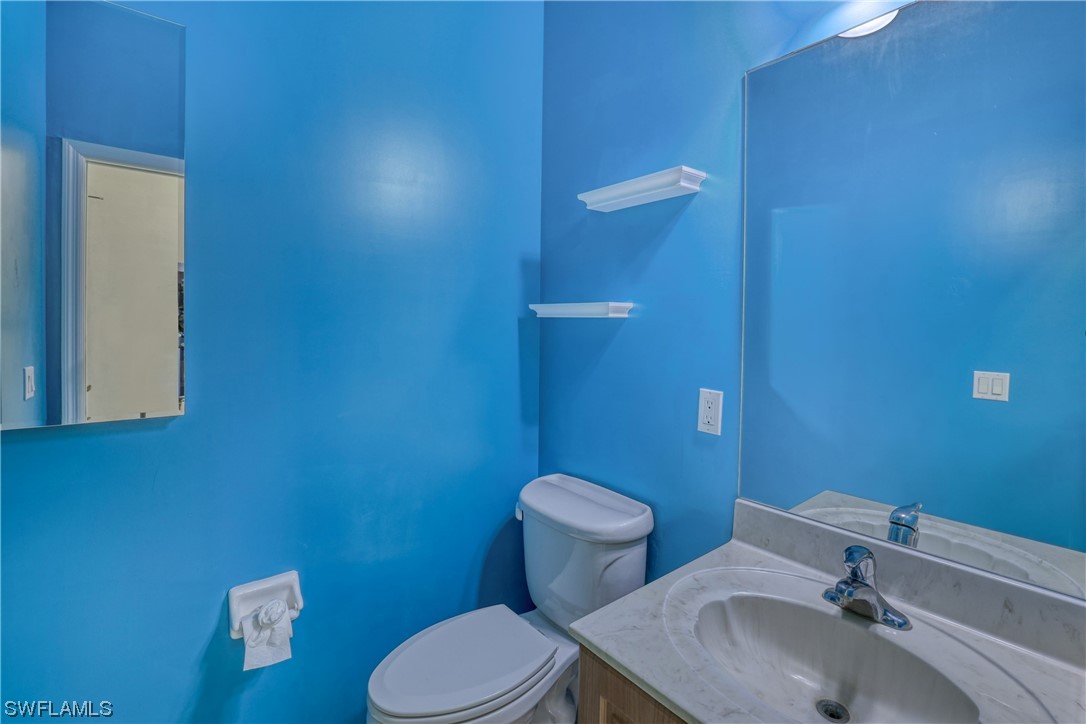 17501 Homewood Road Fort Myers, FL 33967 - Photo 34 of 50 a bathroom with a sink a toilet and mirror