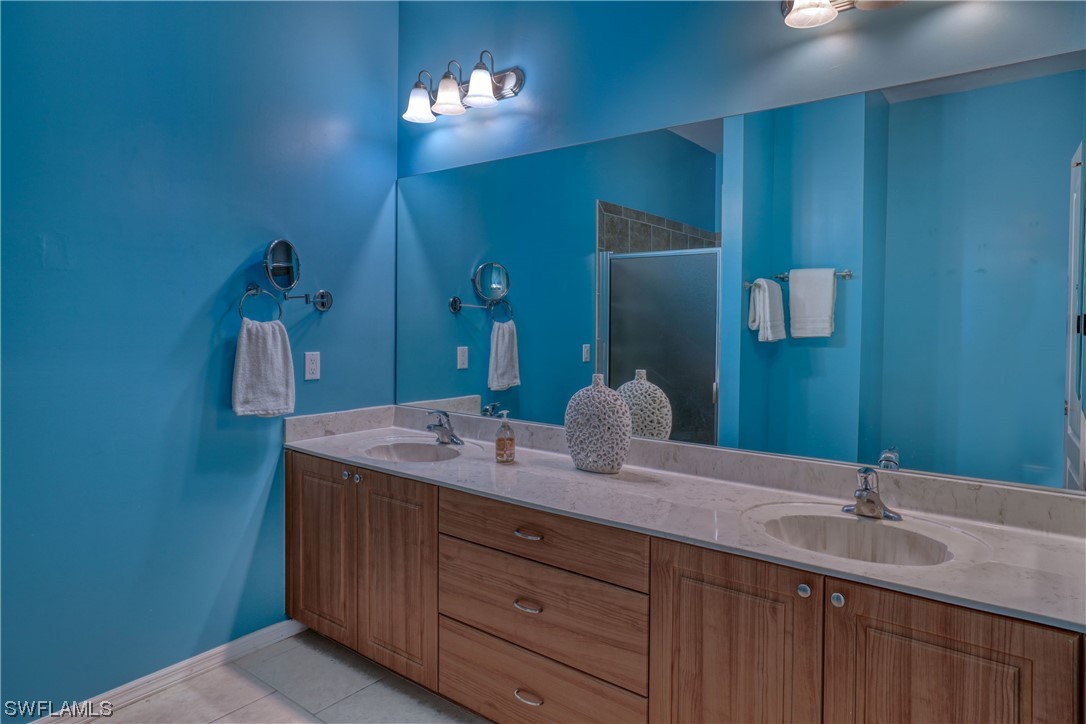 17501 Homewood Road Fort Myers, FL 33967 - Photo 38 of 50 a bathroom with a granite countertop sink and a mirror