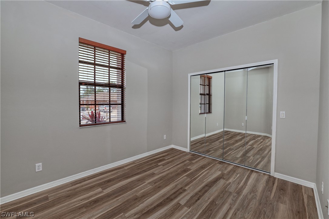 17501 Homewood Road Fort Myers, FL 33967 - Photo 42 of 50 a view of an empty room with wooden floor and a window
