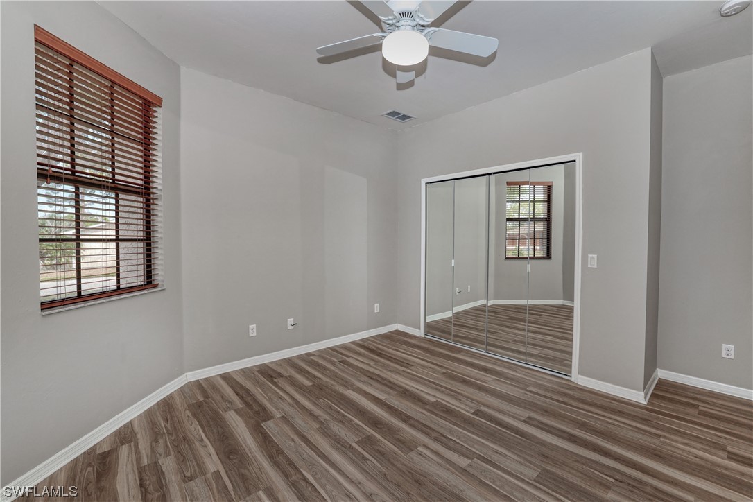 17501 Homewood Road Fort Myers, FL 33967 - Photo 45 of 50 a view of an empty room with wooden floor and a window