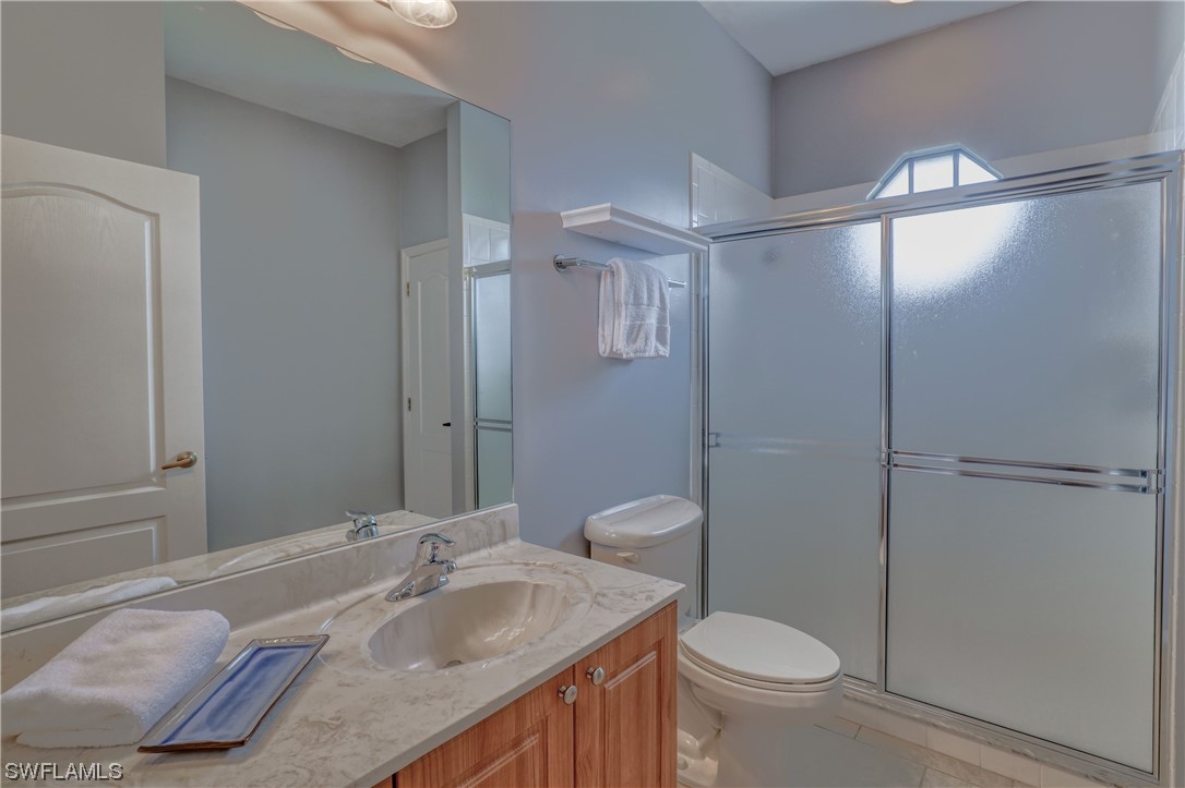 17501 Homewood Road Fort Myers, FL 33967 - Photo 46 of 50 a bathroom with a granite countertop sink toilet and shower
