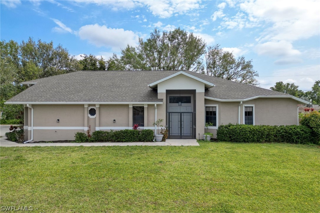 17501 Homewood Road Fort Myers, FL 33967 - Photo 47 of 50 a front view of a house with a yard and garage