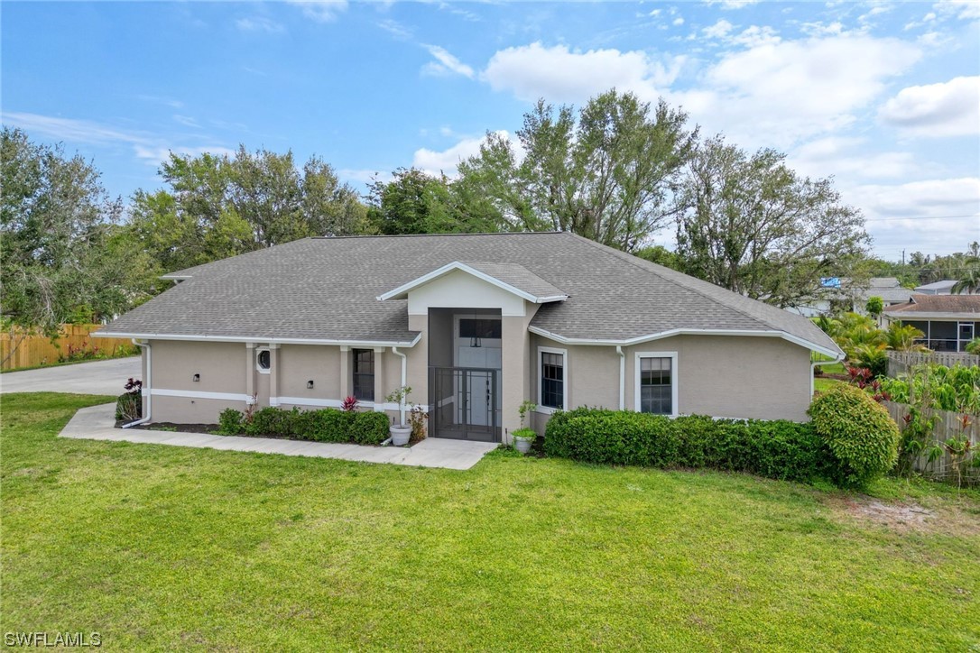 17501 Homewood Road Fort Myers, FL 33967 - Photo 48 of 50 a front view of house with yard and green space