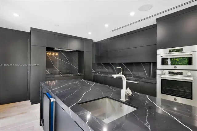 a living room with furniture and large windows