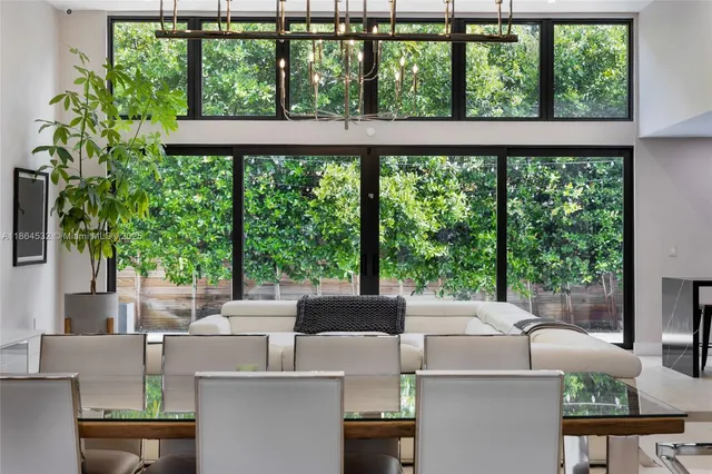 an empty room with floor to ceiling window and an outdoor view