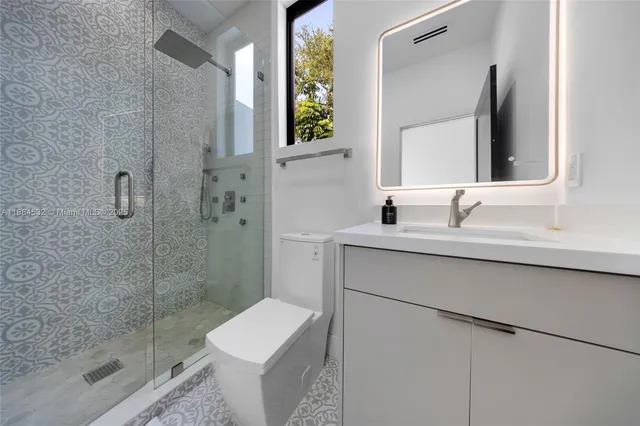 a view of a tennis ground with large trees