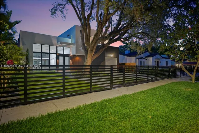a view of an empty room with glass door and garden