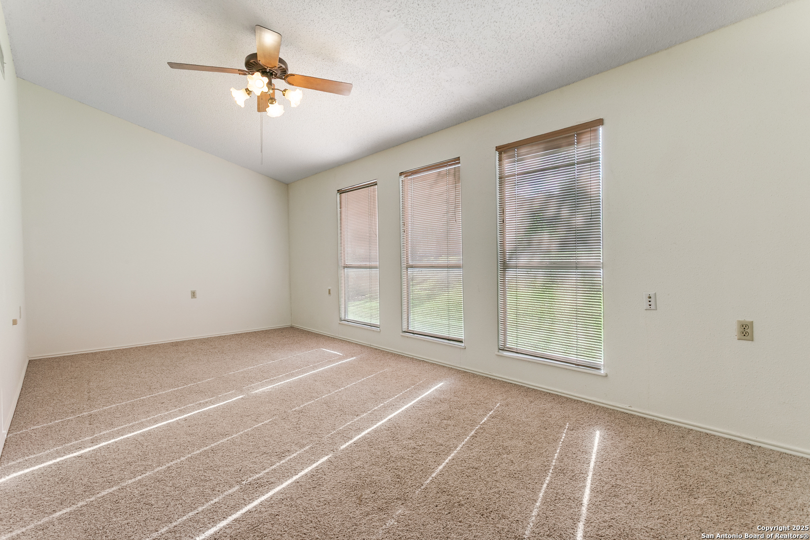 3629 Fox Run Schertz, TX 78108 - Photo 11 of 25 an empty room with chandelier fan and windows