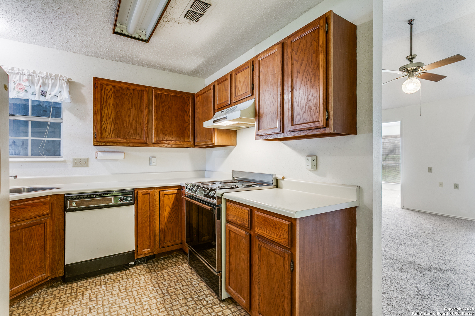 3629 Fox Run Schertz, TX 78108 - Photo 9 of 25 a kitchen with stainless steel appliances granite countertop a sink stove and cabinets
