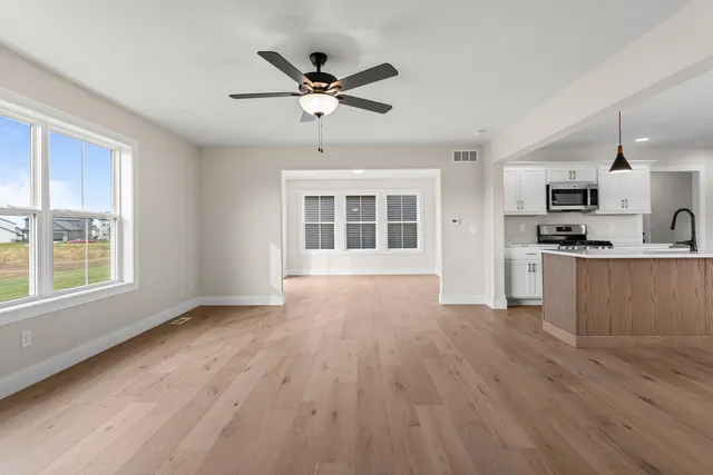 a view of a kitchen with a sink dishwasher and wooden floor