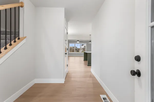 a view of a hallway with a kitchen