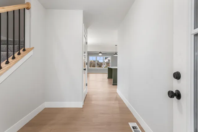 a view of a hallway with a kitchen