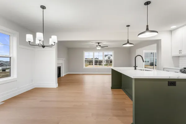 a view of a kitchen with a sink appliances and a chandelier