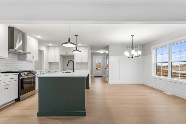 a large kitchen with kitchen island a sink stainless steel appliances and cabinets