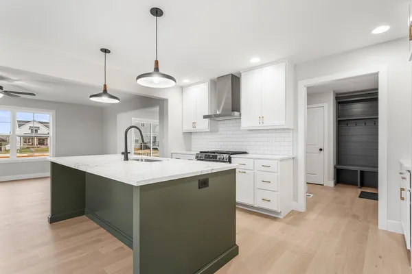 a kitchen with a sink stainless steel appliances and cabinets