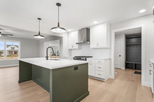 a kitchen with a sink stainless steel appliances and cabinets