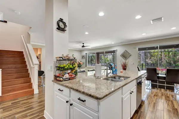 a dining room with furniture wooden floor and a potted plant