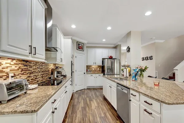 a spacious bedroom with a bed a couch and a large window