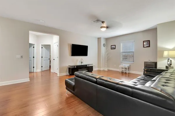 a bedroom with a bed and a painting on the wall