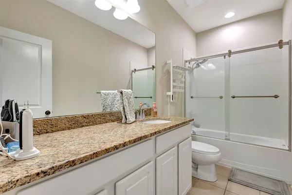 a front view of a house with a yard and palm tree